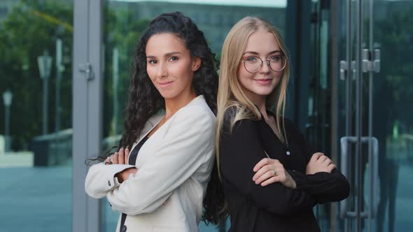 Portrait of Smiling Millennial Young Blonde Woman in Glasses and Millennial Brunette Standing Posing alt