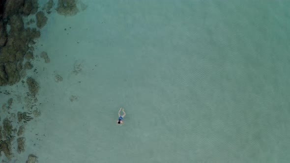 Beautiful young woman swimming in crystal clear sea