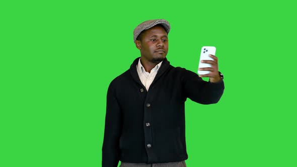 Handsome Black Man in a Hat Taking Selfie on a Green Screen Chroma Key alt