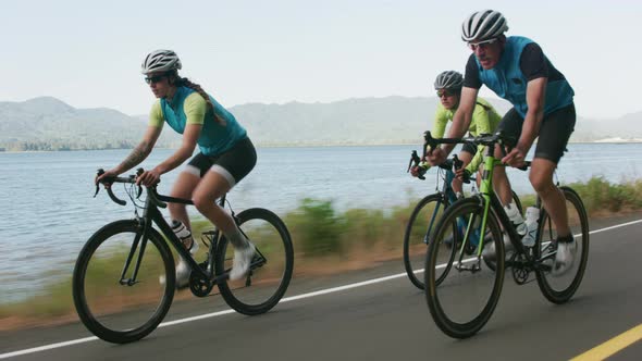 Tracking shot of a group of cyclists on country road.  Fully released for commercial use.