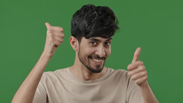 Friendly Arabic Man Stand in Green Studio Make Thumb Up Gesture Both Hands Show Like Everything Okay alt