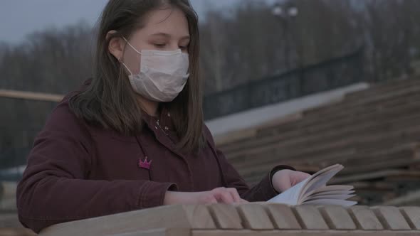 Young Girl in Black Mask Alone Outdoors. Coronavirus Pandemic
