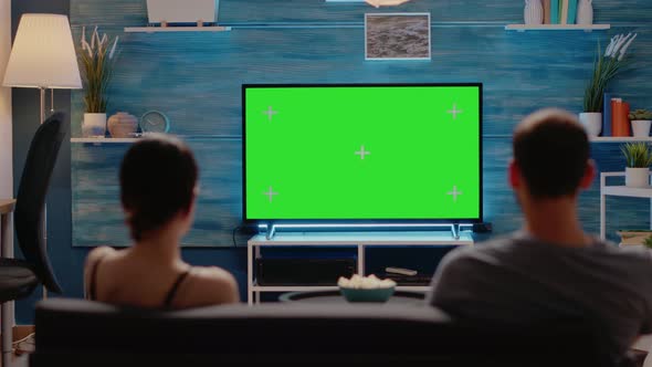 Caucasian Man and Woman Looking at Green Screen alt