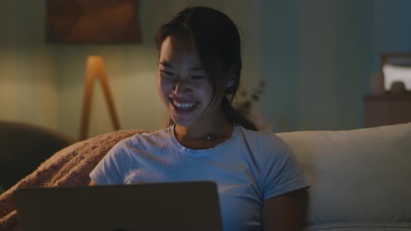 Happy Female Making Video Call in Evening alt
