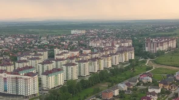 Aerial view of residential town area with apartment buildings and streets alt