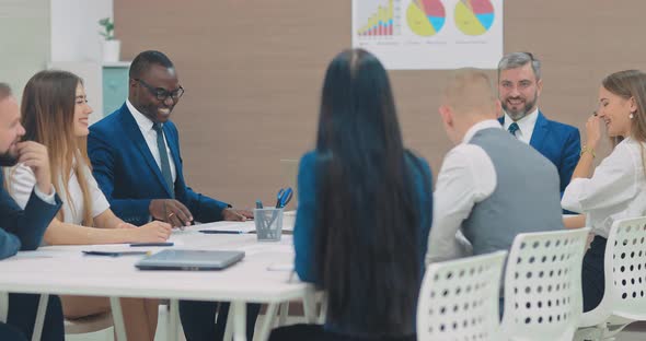 Happy Employees are Sitting at the Conference Table in the Conference Room Discussing a Financial alt