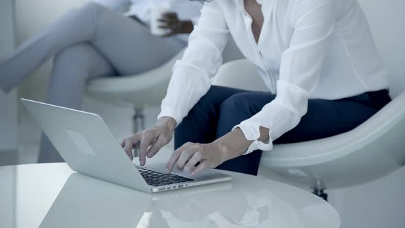 Cropped Shot of Businesswoman Using Laptop alt