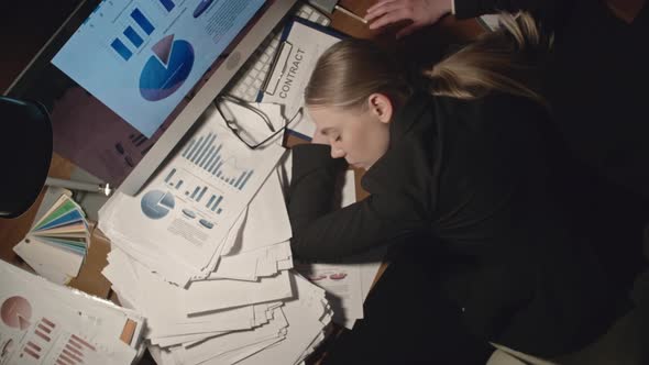 Exhausted Woman Sleeping at Workplace alt