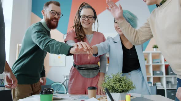 Portrait of Business Team Girls and Guys Joining Hands Expressing Unity in Office alt