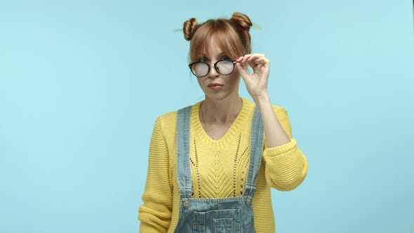 Young Woman with Bangs Wearing Casual Clothes Takeoff Glasses and Squinting Staring at Camera with