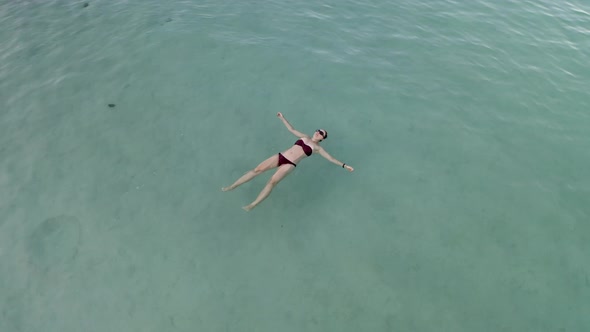 Top view of Beautiful young woman swimming