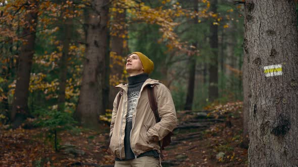 Satisfied Traveler Hipster Stands in Picturesque Place of Wildlife Looks at Autumn Landscape and alt
