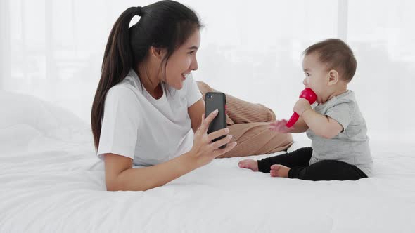 A single mother video call with a smartphone with her baby girl