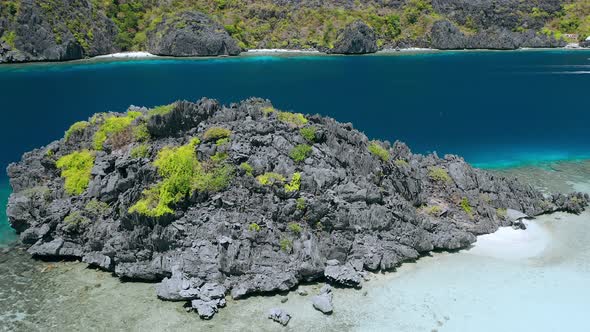 Aerial Drone Reveal Movement of Huge Cliff Rocks in Front of Hidden Lagoon of Star Beach on Tapiutan alt