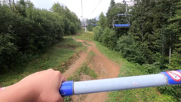 Girl Rides or Climbs on Lift or Cable Car Up Mountain alt