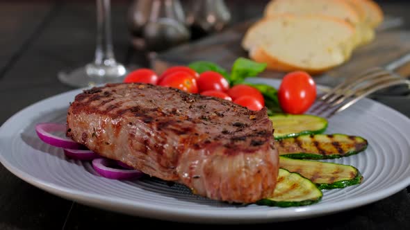 Juicy Grilled Beef Steak And Zucchini Served With Fresh Tomato Cherry And Basil On Wooden Board