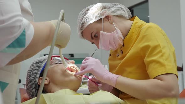 Close Up Female Hands Professional Doctor Stomatologist at Work, Person Undergoes a Medical alt