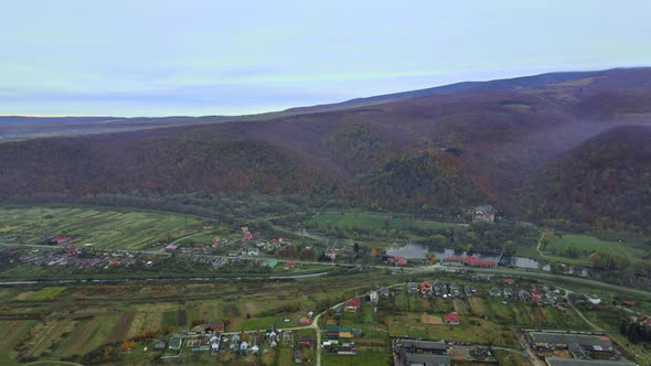 Aerial view in the mountain valley autumn landscape with small village alt
