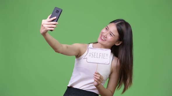 Young Beautiful Asian Businesswoman Using Phone