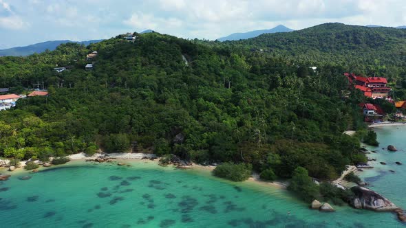 Wide angle birds eye tourism shot of a sunshine white sandy paradise beach and aqua blue water background alt