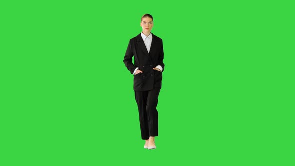 Young Woman in Office Suit Walking in Fashionable Style on a Green Screen Chroma Key alt