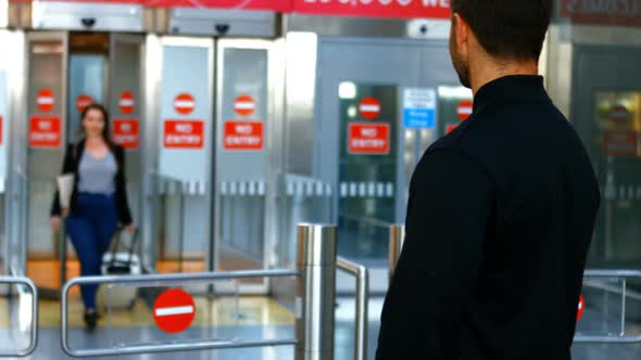 Man embracing woman while arriving alt