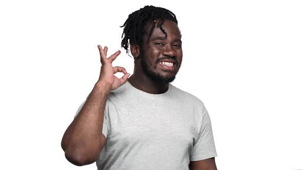 Portrait of Big African American Man Wearing Afro Hairdo and Mustache Showing Alright Sign with alt