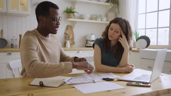 Black Man Realtor Shows the Layout and Tells the Buyer the Options for the Apartment While Sitting alt