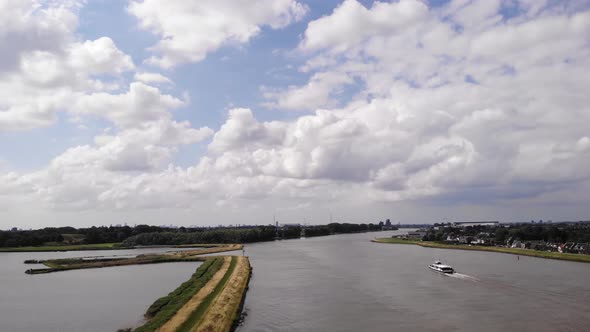 Aerial View Of River Noord With Fluffy Clouds In The Sky. Slow Dolly Forward alt