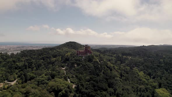 Panoramic panning shot on Sintra Hills overlooking at historic monument Pena palace and cloudscape. alt