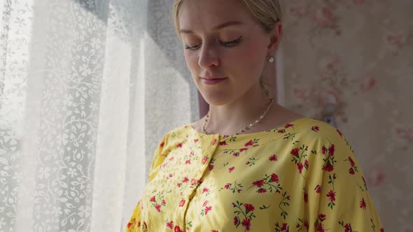 Pregnant Woman Looking at Her Belly alt