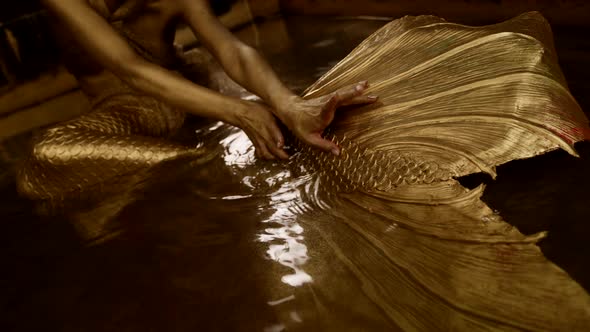 Closeup of Female Hands in Gold Touching a Silicone Tail Like a Mermaid in a Fairy Tale alt