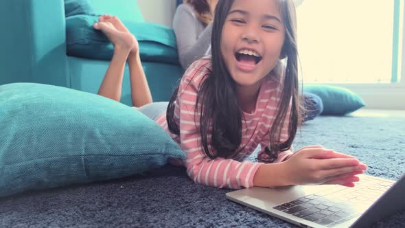 young asian daughter child happiness lay down study online e-learning alt