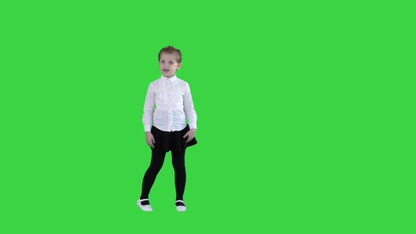 Cute Little Girl Smiling and Confidently Talking To Camera on a Green Screen, Chroma Key alt