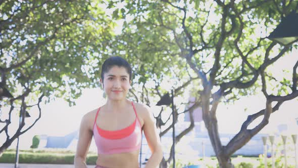 Young Woman Running in Park alt