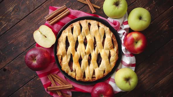 Homemade Pastry Apple Pie with Bakery Products on Dark Wooden Kitchen Table alt