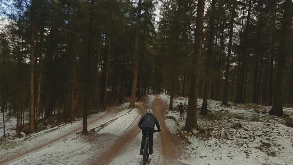 Drone Following Mountain Biker Leaping Over Hills alt