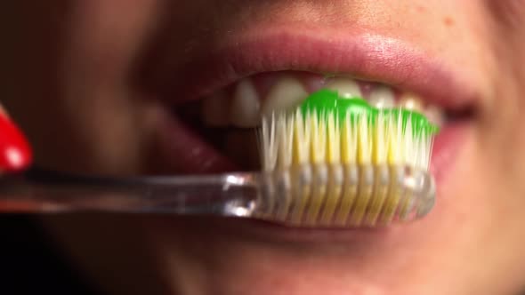 Close View of Woman Mouth While Brushing Teeth. Cleaning and Whitening Teeth.