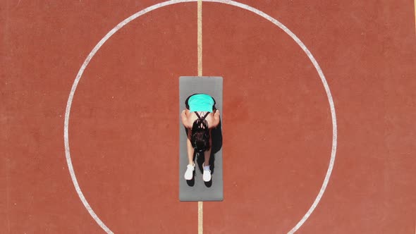Aero, Top View, Fitness Woman in Sportswear Doing Various Exercises. Background of Orange Basketball alt