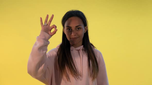 Happy African Girl Making Okay Hand Gesture and Thumbs Up alt