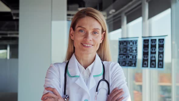 Happy Adult American Woman Doctor Looking at Camera in Hospital alt