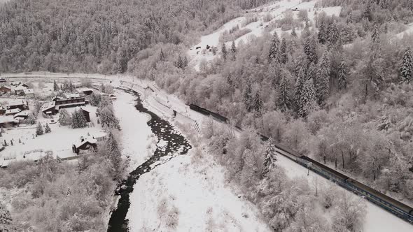 Train Moving Across Small Village In Winter