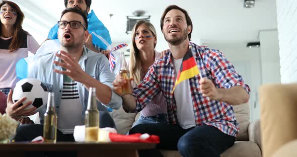 Soccer Fans Emotionally Watching Game in the Living Room