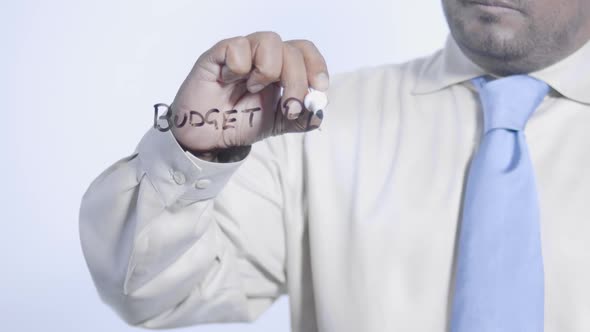 Asian Businessman Writes Budget Plan
