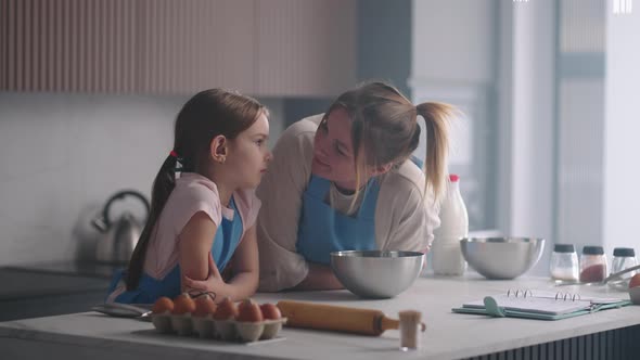 Mother and Preschooler Girl are Spending Time Together in Kitchen in Apartment Family Weekend at alt