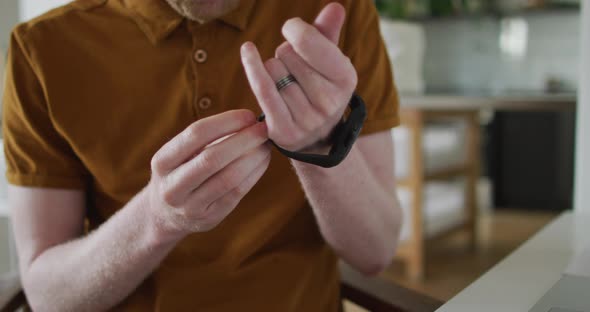 Albino african american man with dreadlocks using smartwatch alt