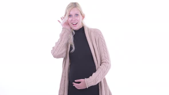 Happy Young Blonde Pregnant Woman Thinking and Listening alt