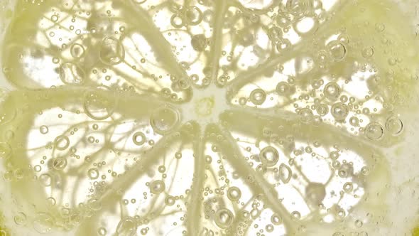 Water with Lemon Slices and Exploding Soda Air Bubbles alt