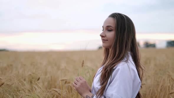 Romantic and Carefree Young Woman in Slow Motion Video Walking on Field Wheat Enjoying Freedom and