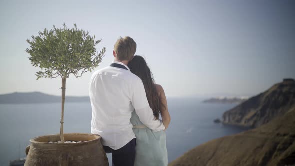 Romantic Couple Beside Little Olive Tree on Santorini Island